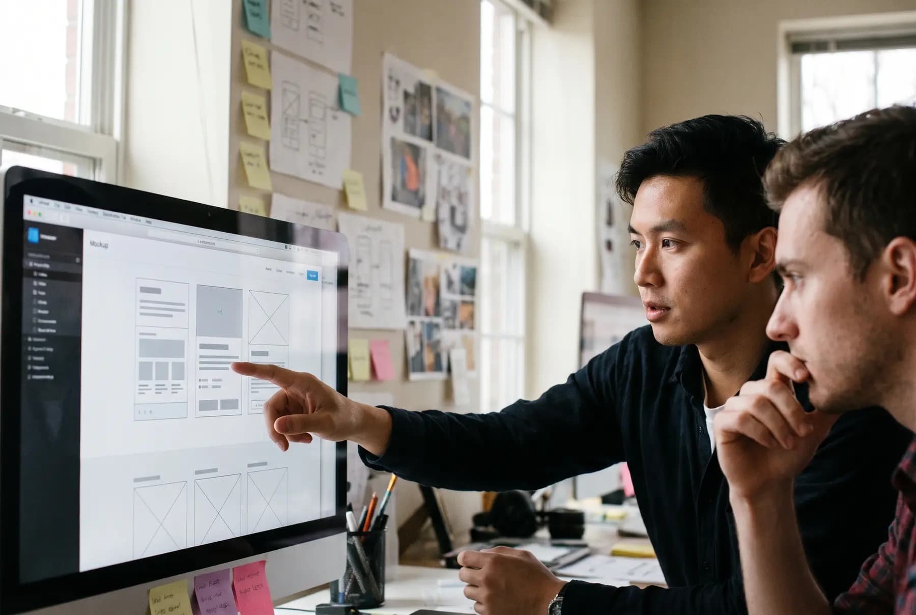 Two designers reviewing a website layout together